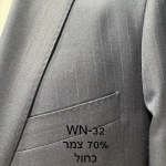 חליפת Adore דגם WN-32 בצבע כחול כהה עם פסי סיכה עדינים ו-70% צמר, צילום תקריב של דש הז'קט, כיס החזה ומרקם הבד